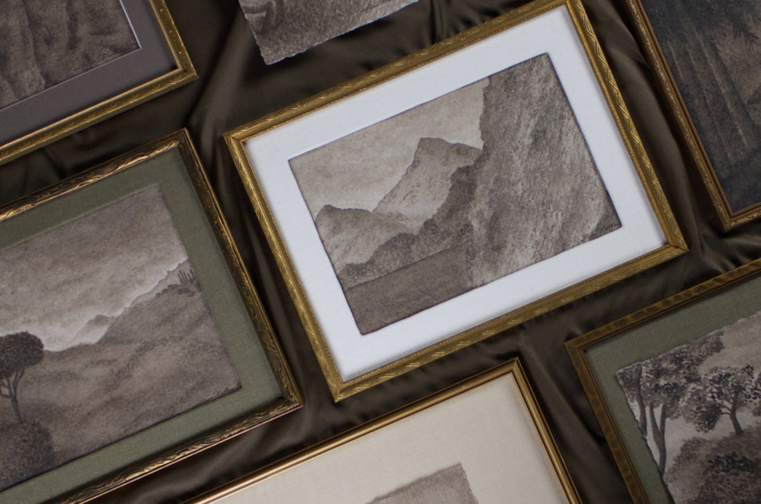 framed vintage style watercolour paintings arranged on table